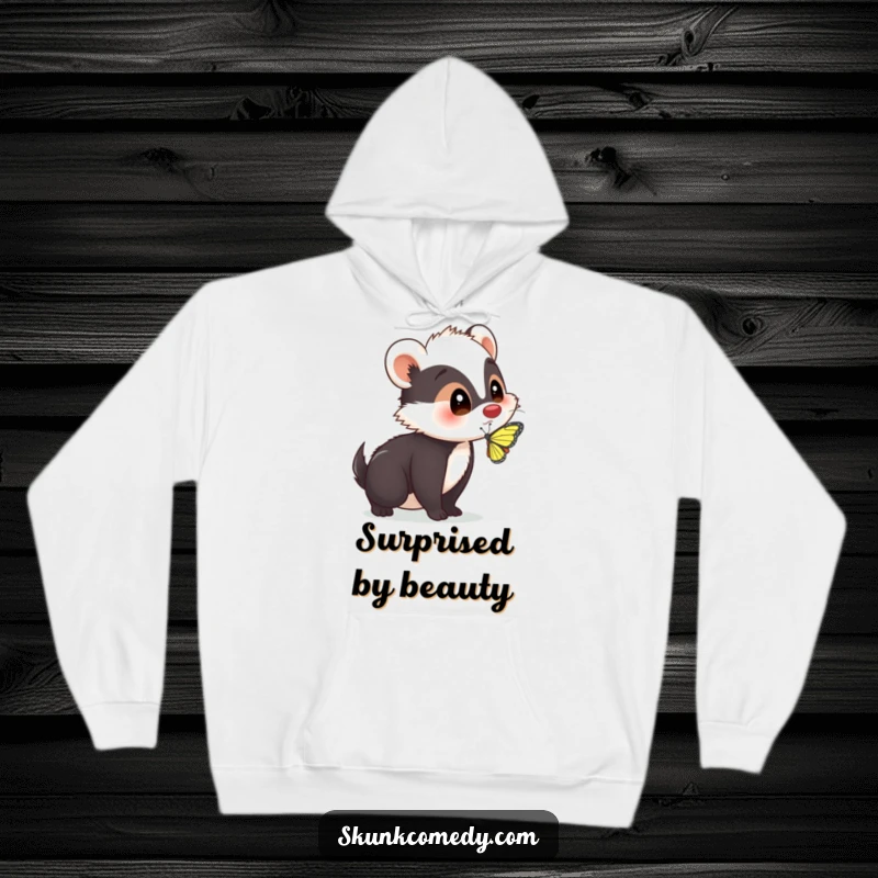 A cozy hoodie featuring a funny skunk with a surprised expression as a butterfly lands on its nose, offering comfort and amusement.